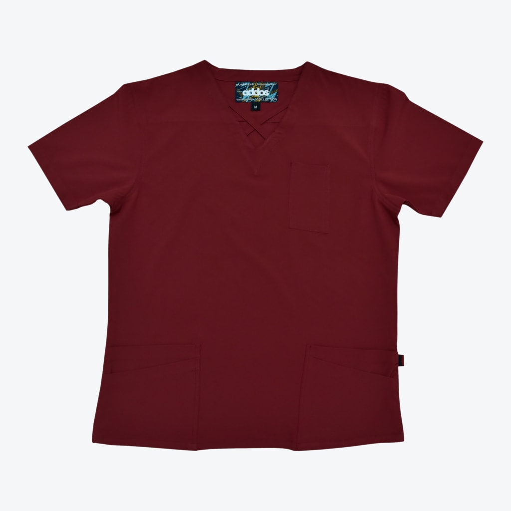 A flat lay photograph of a maroon short-sleeved scrub top with a criss-cross V-neck, a chest pocket, and two lower front pockets against a plain white background.