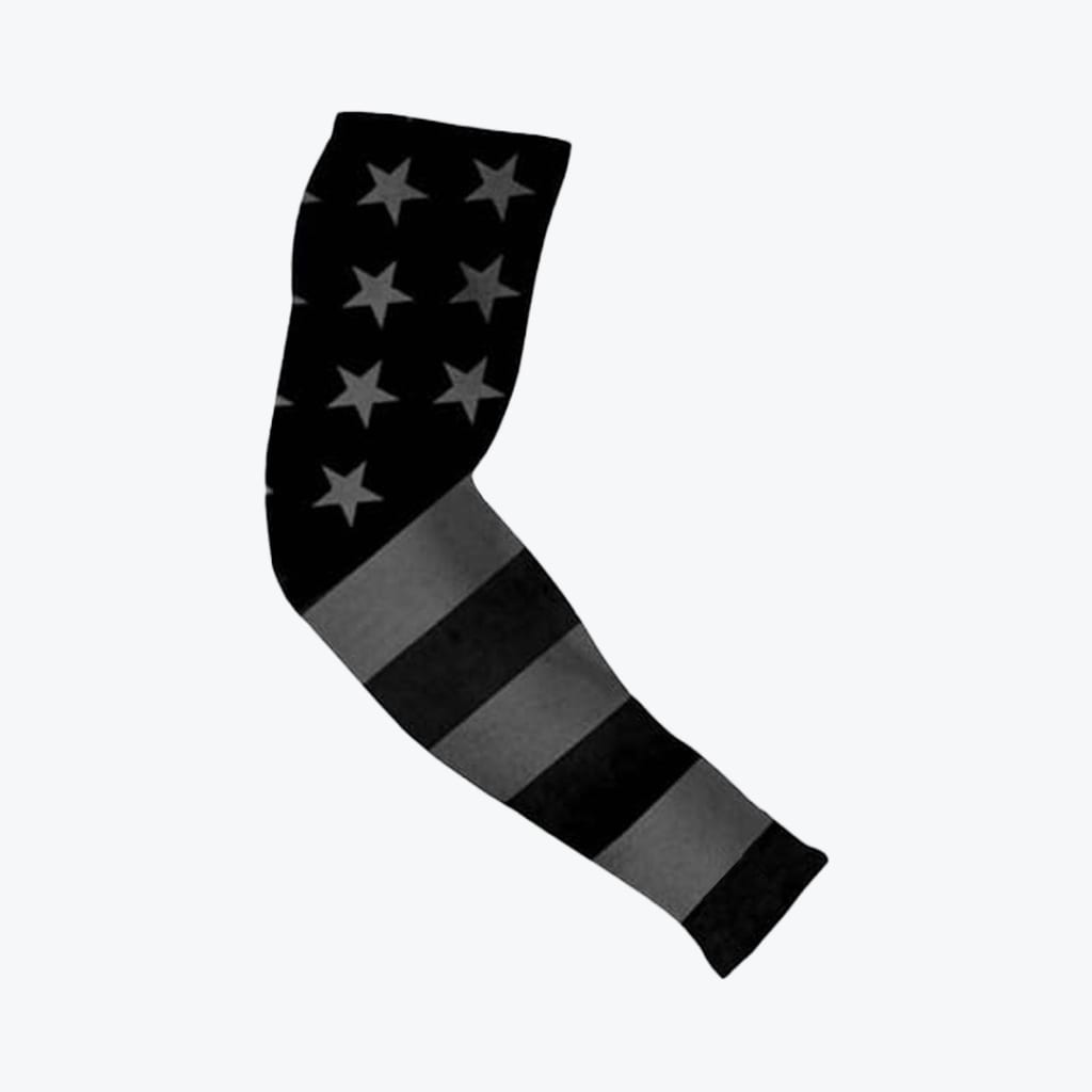 A black and grey compression arm sleeve featuring a monochrome American flag design with stars on the upper half and stripes on the lower half.