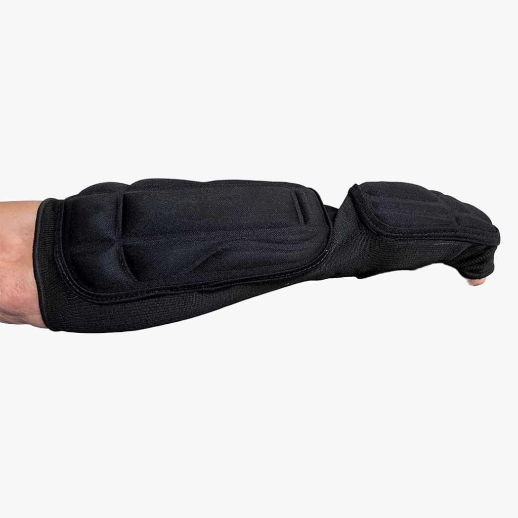 A black padded forearm and wrist guard sleeve worn on an arm, showcasing its segmented protective foam design against a white background.