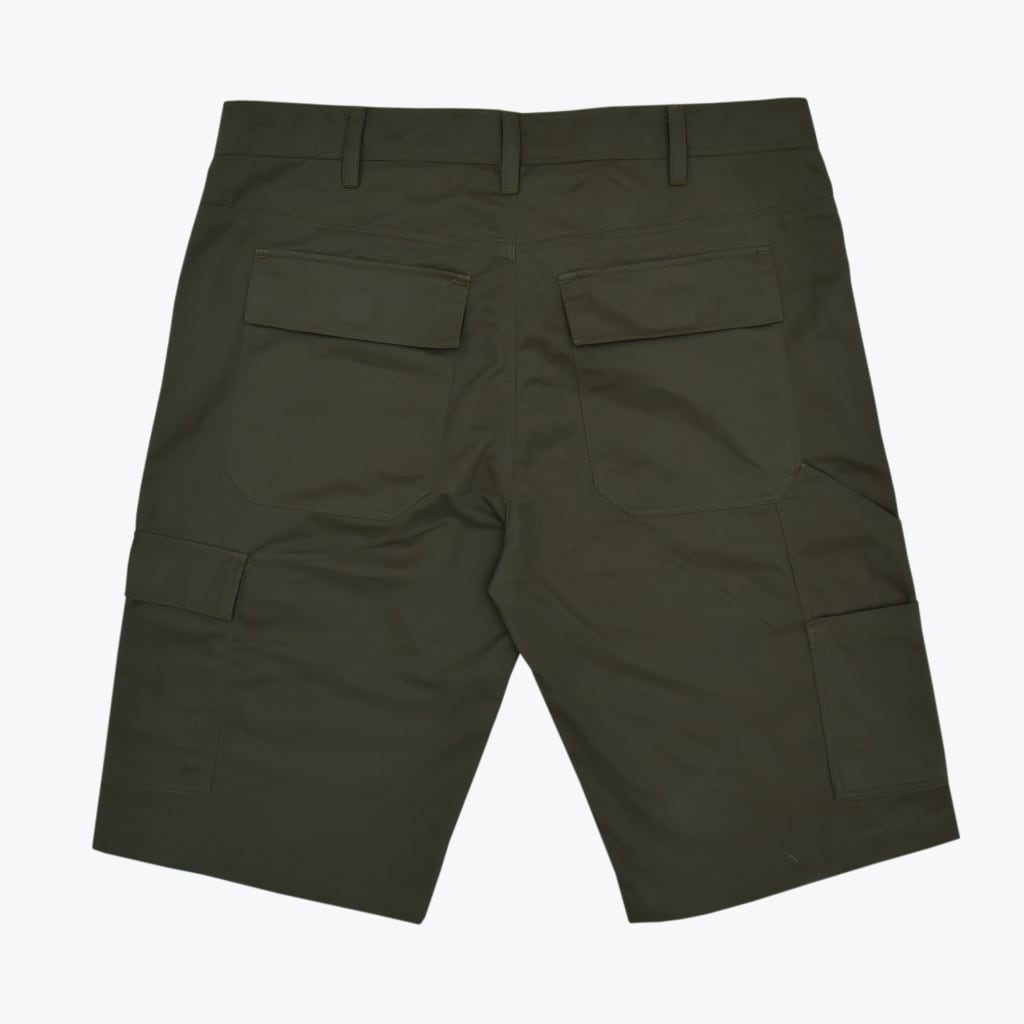 Back view of dark olive green cargo shorts with flap pockets and belt loops on a white background.