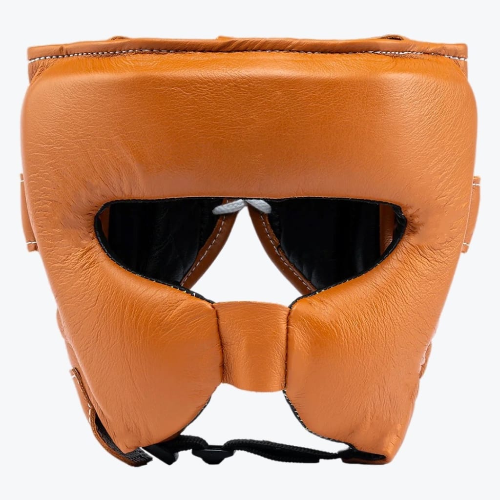 Front view of a tan leather boxing headguard with cheek protection on a white background.