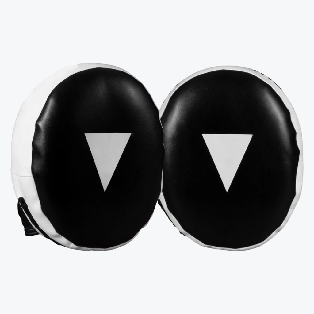 A pair of black and white oval-shaped boxing focus mitts with white inverted triangle targets in the center, set against a plain white background.