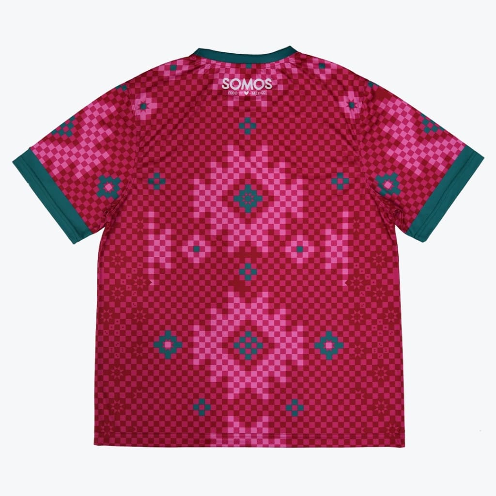 Back view of a magenta and pink checkered jersey with teal trim and geometric patterns, featuring the SOMOS logo near the neckline.