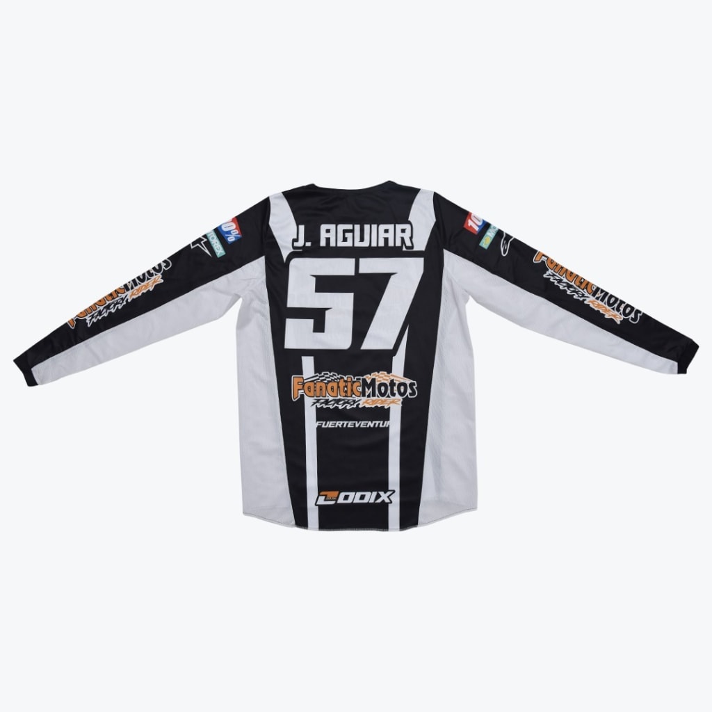 Back view of a black and white motocross jersey with J. AGUIAR and the number 57 printed on the back.
