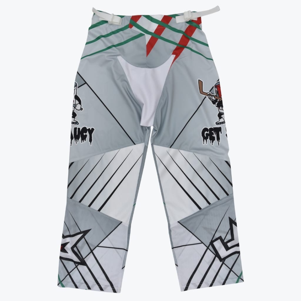 Front view of grey and white roller hockey pants featuring geometric patterns, mesh panels, and cartoon graphics with the text GET SAUCY.