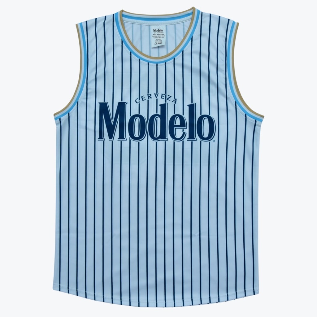 A light blue sleeveless jersey with dark blue pinstripes and the Cerveza Modelo logo on the chest, set against a white background.