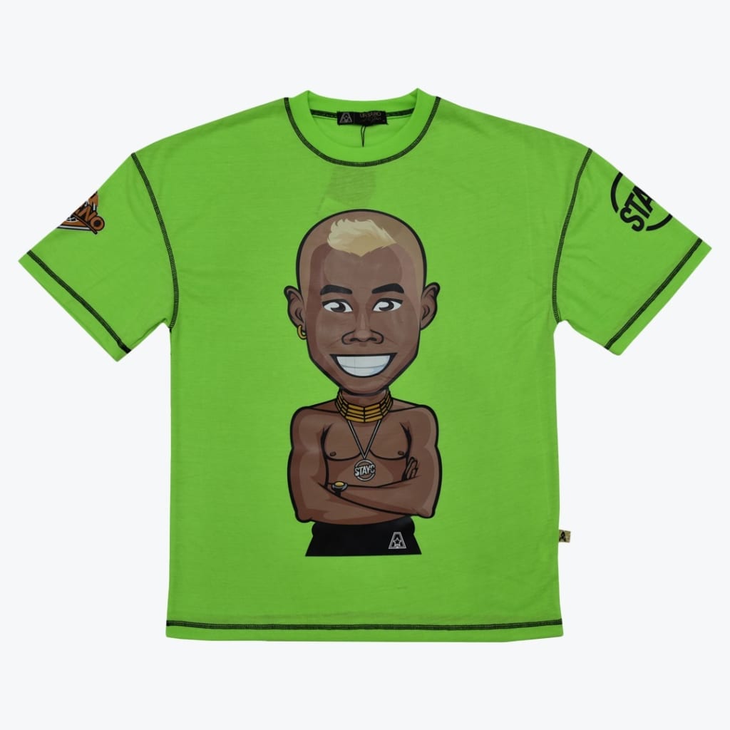 A bright lime green t-shirt with black contrast stitching, featuring a central cartoon illustration of a smiling, shirtless Black man with a blonde mohawk and gold neck rings.