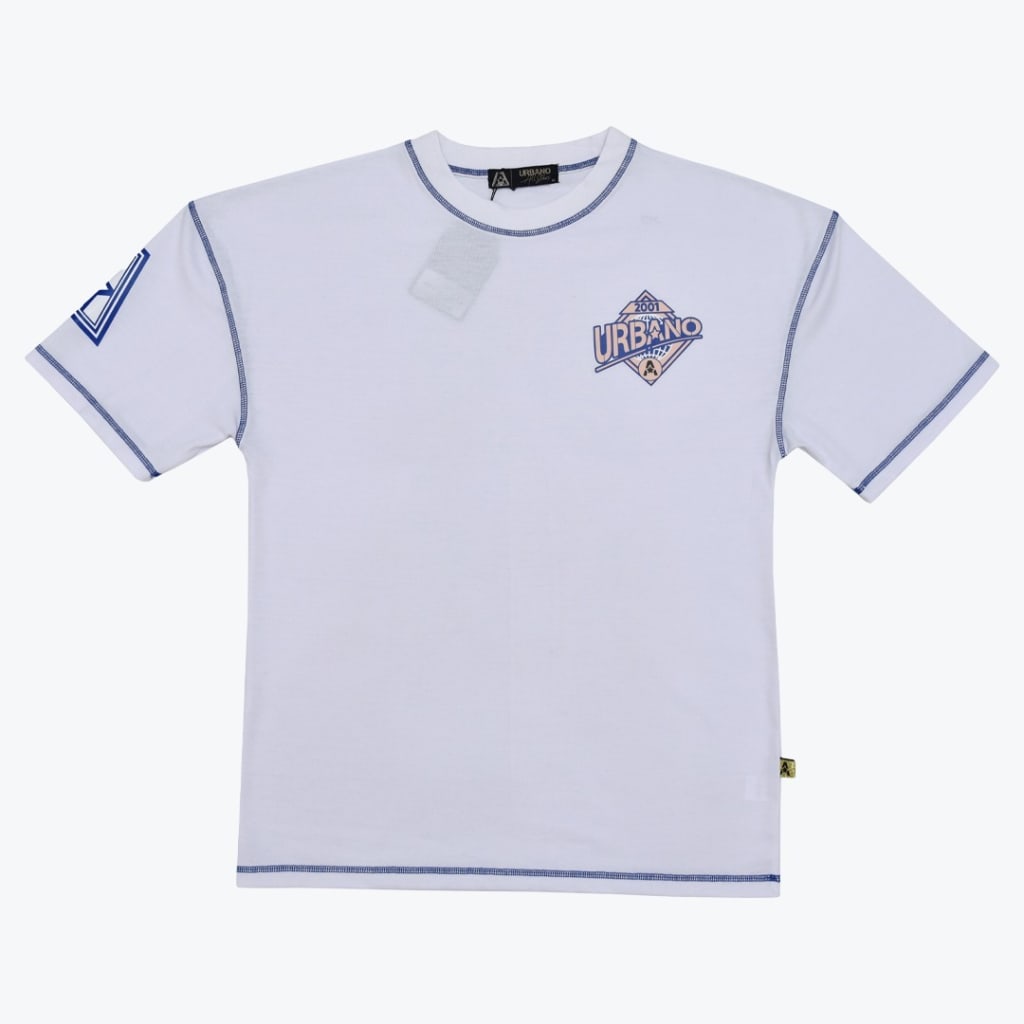 A flat-lay view of a white t-shirt with blue contrast stitching, a chest graphic reading URBANO 2001, and a sleeve logo.
