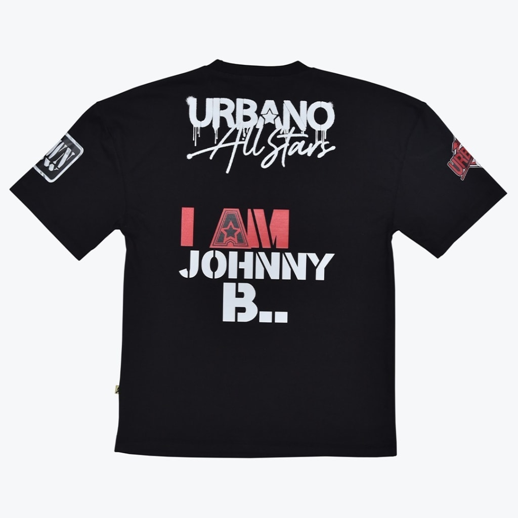 The back view of a black t-shirt with white and red graphic text that reads URBANO All Stars and I AM JOHNNY B...