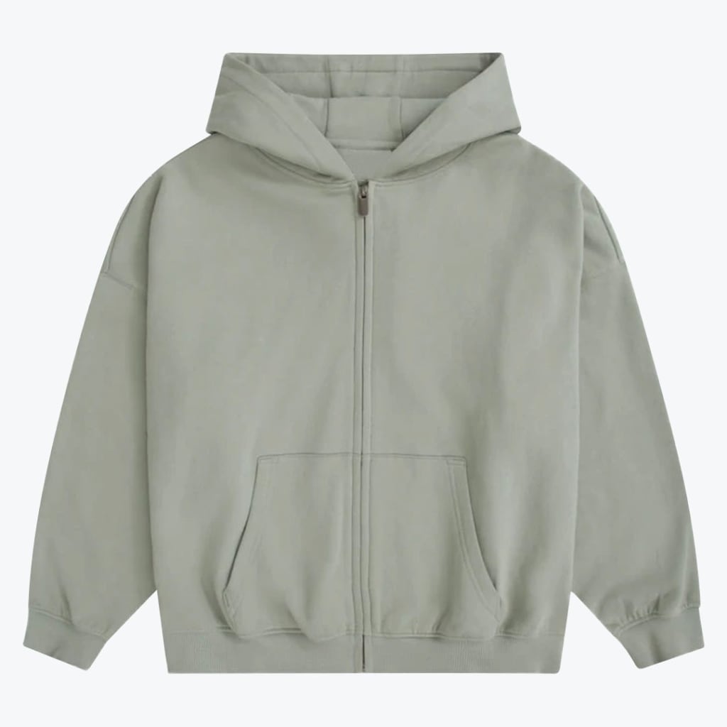 A light sage green zip-up hoodie with a hood, front zipper, and kangaroo pockets, displayed against a plain white background.