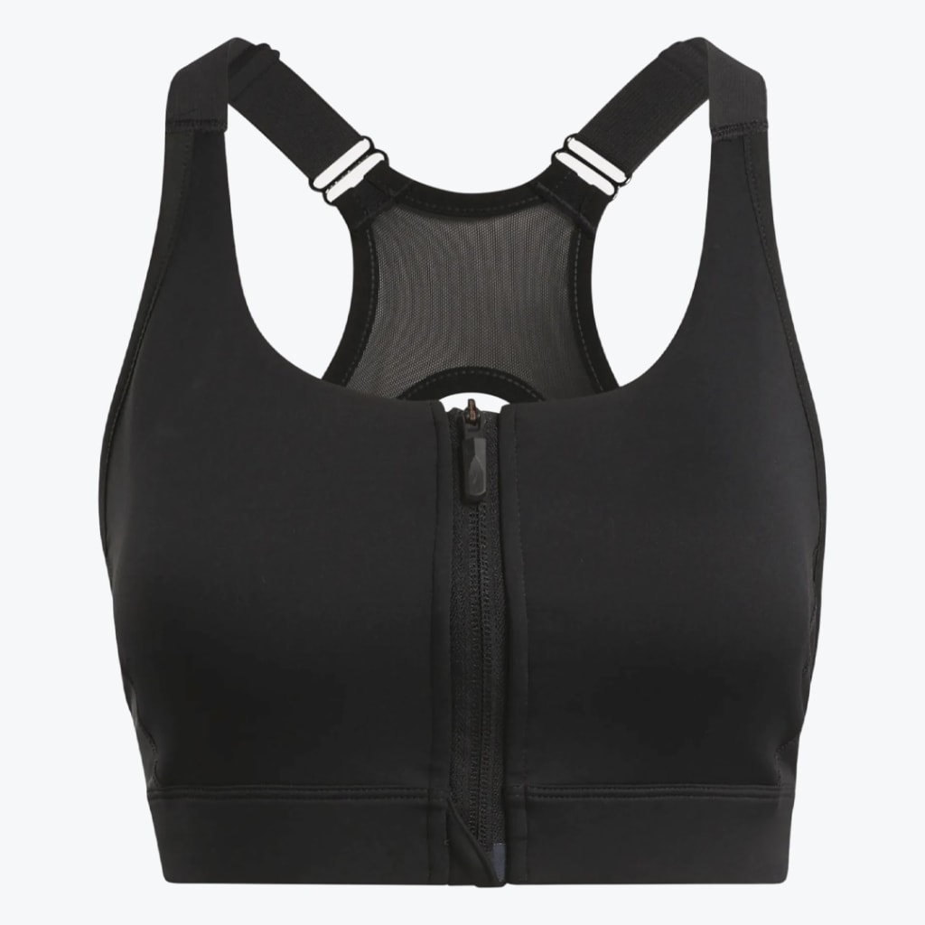 Front view of a black sports bra with a front zipper, adjustable straps, and a mesh racerback panel on a white background.