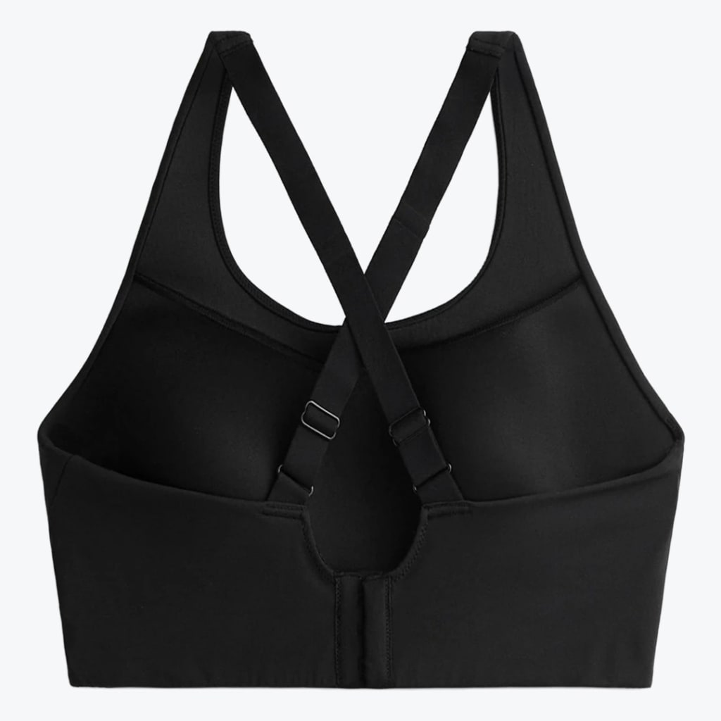 Back view of a black sports bra with adjustable cross-back straps and a hook-and-eye closure on a plain white background.