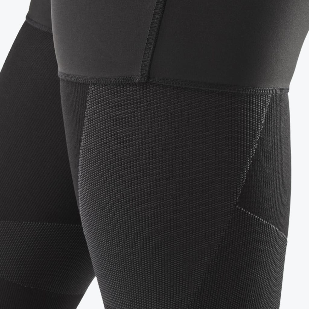 Close-up of the textured fabric and stitching on a pair of black compression leggings.