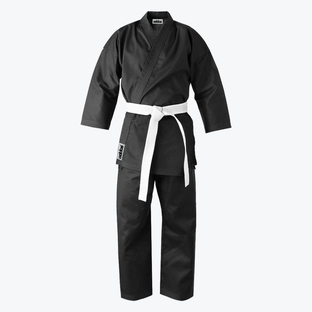 A front-facing studio shot of a black martial arts gi with a white belt tied around the waist.