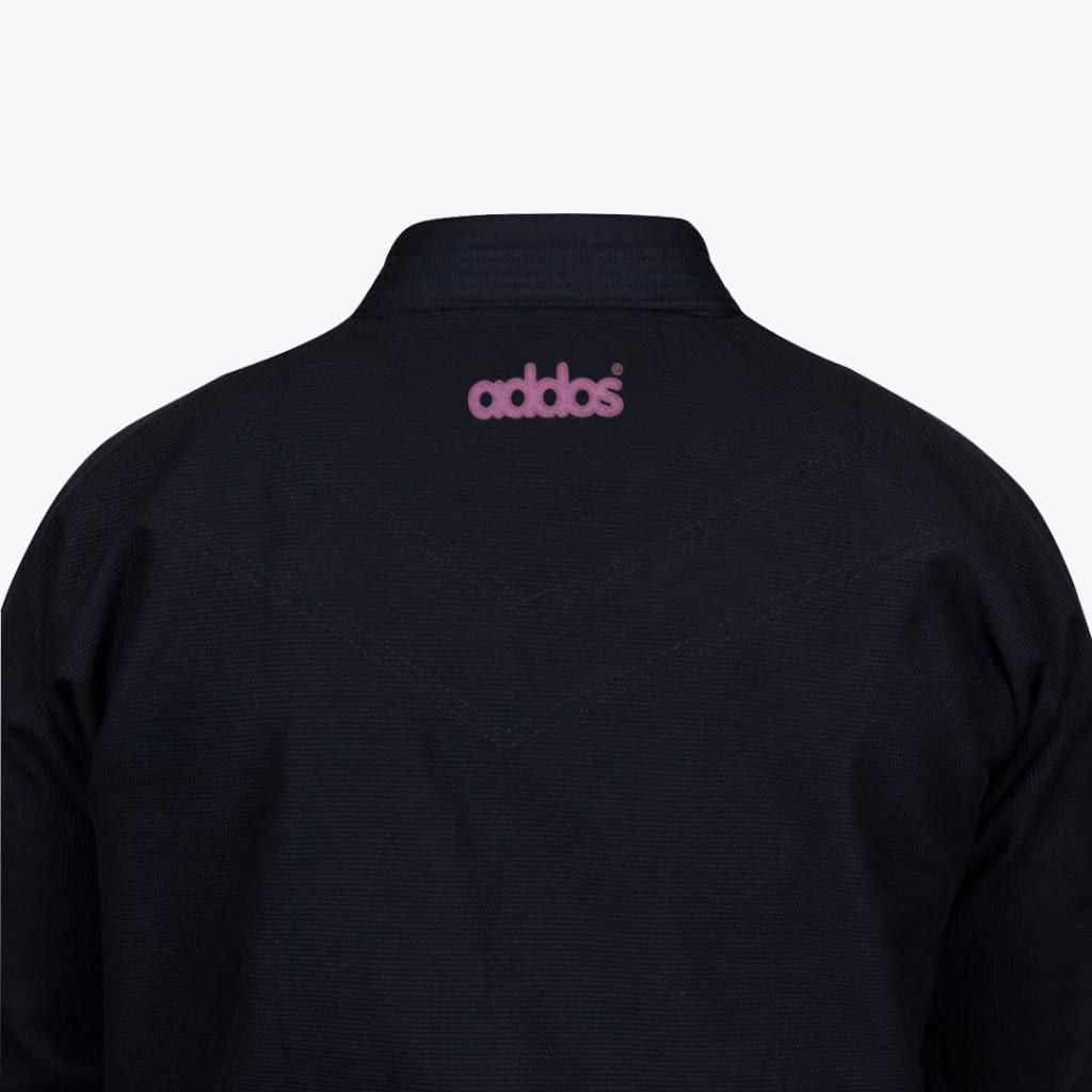 Close-up of the back of a black martial arts gi jacket with a pink embroidered Addos logo on the upper back.
