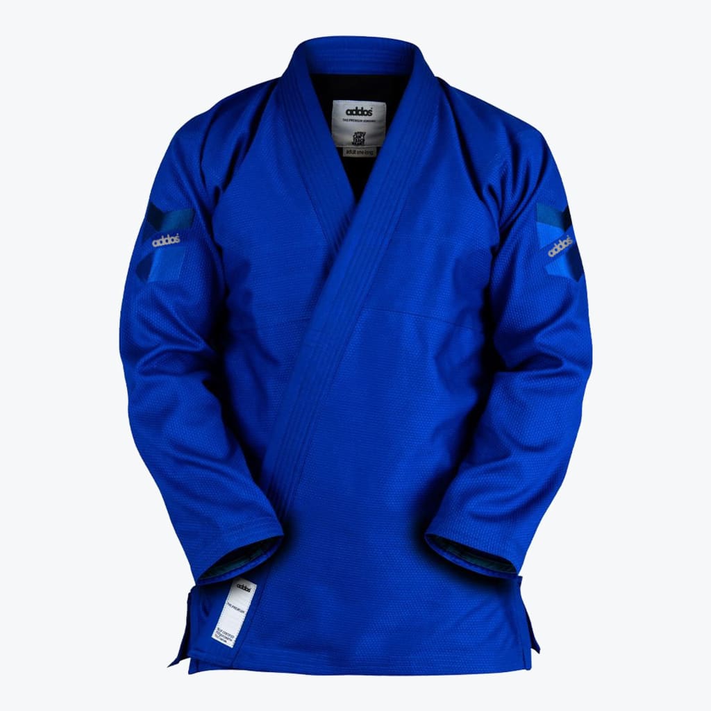 A royal blue Jiu-Jitsu gi jacket with brand patches on the sleeves, displayed against a white background.