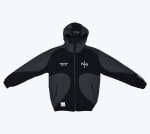 A black and grey hooded zip-up jacket with TRAPX EST.2023 BOXING CLUB printed on the chest.