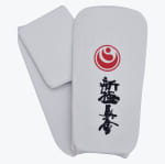 A pair of white fabric karate shin guards with a red circular logo and black Japanese kanji characters on a plain white background.