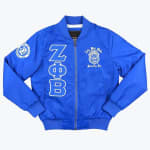 A royal blue bomber jacket with white Zeta Phi Beta Greek letters, crest, and sleeve patch.