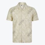 A mens light beige short sleeve button up shirt with a white tropical leaf pattern featuring a camp collar and a chest pocket displayed against a plain white background