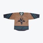 A tan hockey jersey with a leaping panther logo on the chest and teal and grey stripes on the sleeves and hem.