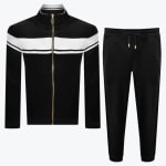 A two-piece mens black velour tracksuit consisting of a full-zip jacket with a white chest stripe and matching black jogger pants.