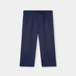 A front-facing view of a pair of navy blue straight-leg trousers with an elastic waistband and drawstring on a light grey background.