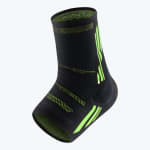 A black and neon green compression ankle sleeve shown at an angle against a white background.