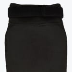 Close-up of a black elastic compression sleeve featuring an adjustable velcro strap at the top.