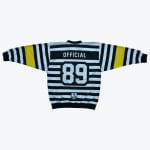 The back view of a black and white horizontally striped long-sleeve jersey with yellow sleeve accents, featuring OFFICIAL and the number 89 printed on the back.