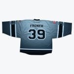 Back of a grey gradient hockey jersey with FRONEK and the number 39 in black. It features a Canadian flag patch on one sleeve and a British Columbia flag patch on the other.