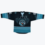 A black, teal, and orange hockey jersey with a Grizzlies logo and a bear paw mountain graphic on the front.
