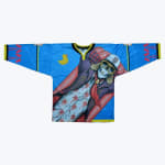 A blue hockey jersey featuring a graphic of a cartoon skeleton in aviator gear lounging on a pool float, with a yellow rubber duck on the chest.