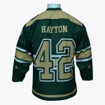 Back of a green hockey jersey with HAYTON and the number 42 in gold lettering on a mannequin.