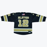 The back of a black sports jersey featuring the name SLATER and the number 12 in gold with white outlines, accented by gold stars on the shoulders and an American flag patch.