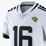 A close-up of a white Jacksonville Jaguars jersey with the number 16 and the team's jaguar head logo on the chest.
