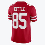 The back of a red San Francisco 49ers jersey with the name Kittle and number 85 in white block lettering.