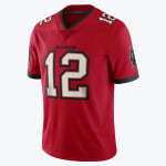 A red Tampa Bay Buccaneers jersey with the number 12 in white with black and orange trim, displayed against a plain white background.