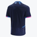 The back view of a navy blue Scotland rugby jersey featuring a small Scottish flag on the upper neck, pink and blue sleeve cuffs, and a patterned lower hem.