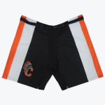 A pair of black athletic shorts with orange and white side panels, featuring an adjustable belt at the waist and a custom C logo with a feathered headdress on the lower left leg.