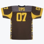 The back view of a brown and yellow football jersey with UPS and the number 07 in yellow.