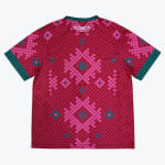 Back view of a magenta and pink checkered jersey with teal trim and geometric patterns, featuring the SOMOS logo near the neckline.