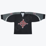 A black hockey jersey with grey shoulders, a red crosshair symbol in the center, and red numbers on the sleeves, laid flat against a white background.