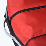 Close-up of a red and black fabric bag showing a black zipper and a grey handle on the side.