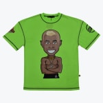 A bright lime green t-shirt with black contrast stitching, featuring a central cartoon illustration of a smiling, shirtless Black man with a blonde mohawk and gold neck rings.