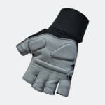 A grey and black fingerless weightlifting glove with padded palm sections and a wide black wrist wrap, shown against a plain light background.