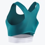 Back view of a teal sports bra featuring a racerback design, a lower back cutout, and a solid white bottom band against a plain white background.