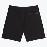 Back view of black boardshorts featuring a horizontal zippered pocket with a red pull tab accent on the right side.
