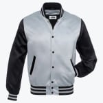 A silver and black satin varsity jacket with snap buttons and striped ribbed trim, displayed against a white background.