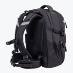 Back and side view of a black ergonomic backpack with padded shoulder straps, a chest strap, a padded back panel, and a waist belt against a plain white background.